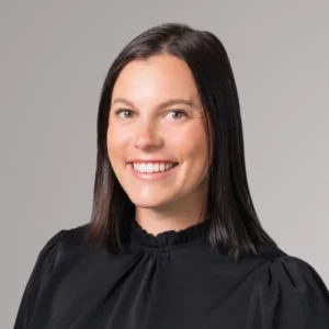 Headshot of Danni Melquist. She wi wearing a black shirt and has long brown hair.