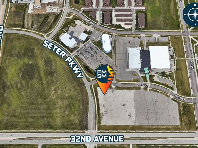 A google map aerial image over Scheels arena parking lot. It also has a google pin with the FMSM logo in the middle. The pin points to the intersection of Seter Pkwy and 31st Ave. S., the future location of FMSM.